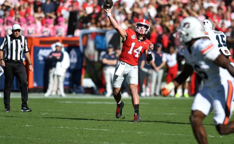 Keith Barlow/CNI News Service. Former Rabun County and current UGA quarterback Gunner Stockton throws downfield to a receiver in Georgia’s 27-24 loss to Auburn on Oct. 17. Stockton finished the game with 272 passing yards and two touchdowns but had three costly turnovers.