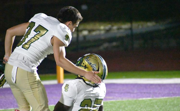 Wesley Branch/The Clayton Tribune. RGNS running back Jordan Lindo (25) and kicker Andres Salazar Duarte celebrate on the field after Rabun Gap’s 28-27 overtime win versus Christian Brothers College on Oct. 2. RGNS faces Christ School next.