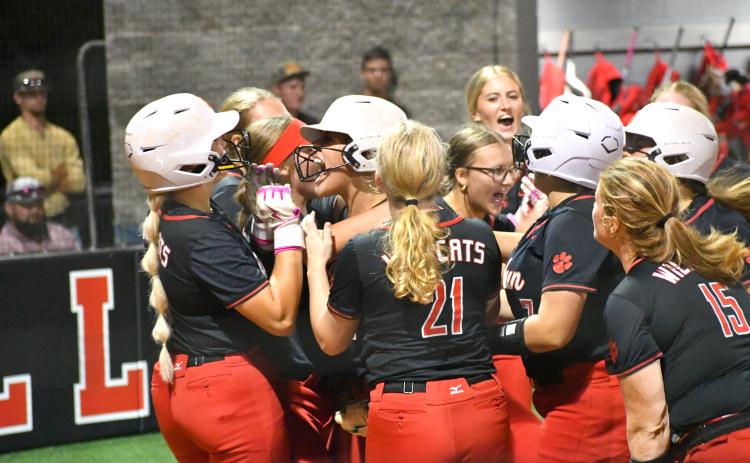 Wesley Branch/The Clayton Tribune. The Rabun County softball team celebrates after a three-run home run by junior River Evans, left, in the sixth inning of the Lady Cats’ 15-10 win over Clarke Central on Oct. 5. Evans’ home run was part of a nine-run sixth inning. With the victory, head coach Jessica Evans collected her 200th career win.