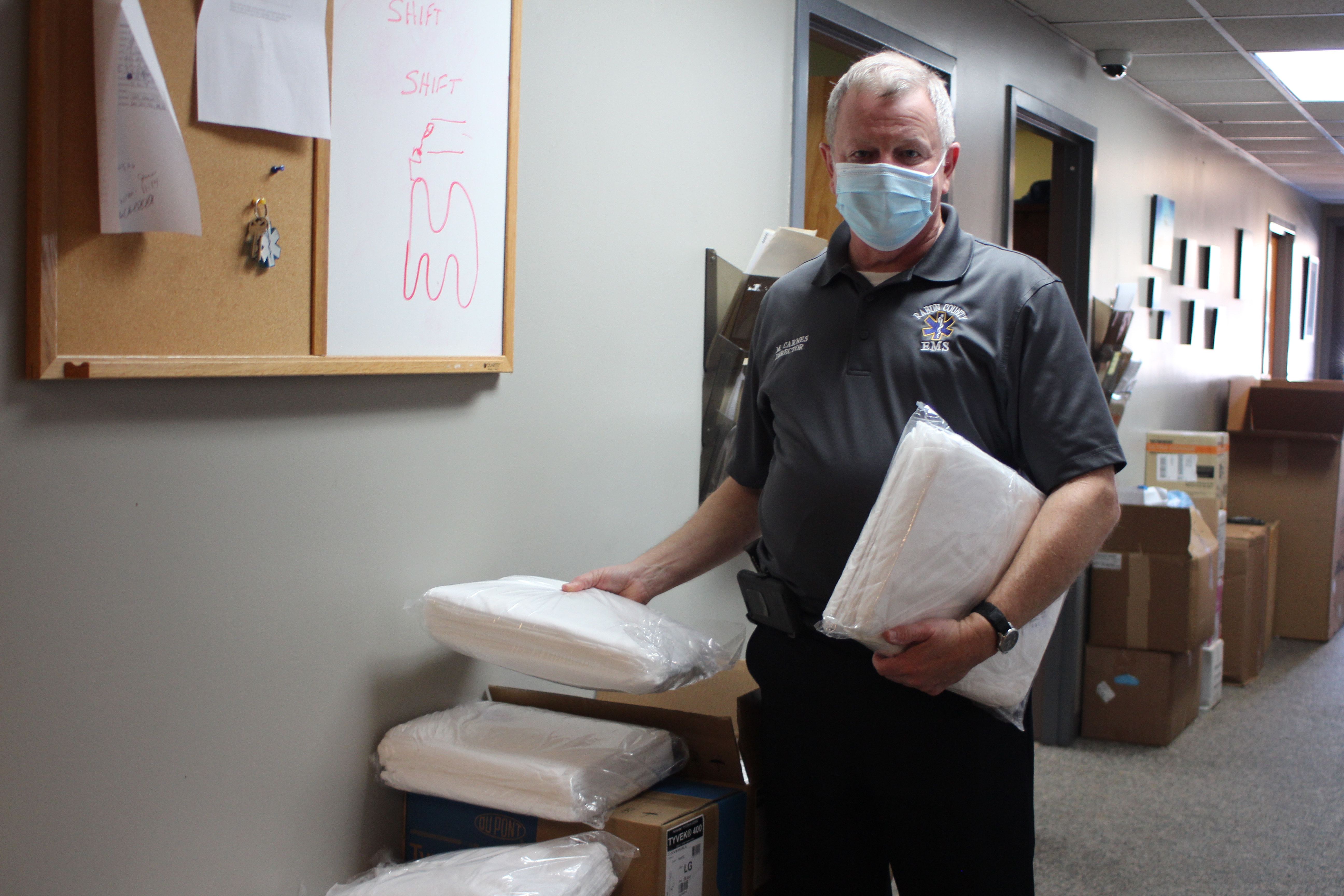 Megan Broome/The Clayton Tribune. Mike Carnes, director of Rabun County EMS and 911, sifts through boxes of supplies and Personal Protective Equipment (PPEs) that personnel use when responding to calls. Supplies were ordered in bulk and Captain Trampes Stancil said that he feels the department is well prepared with PPEs to protect personnel and treat patients during the pandemic. 