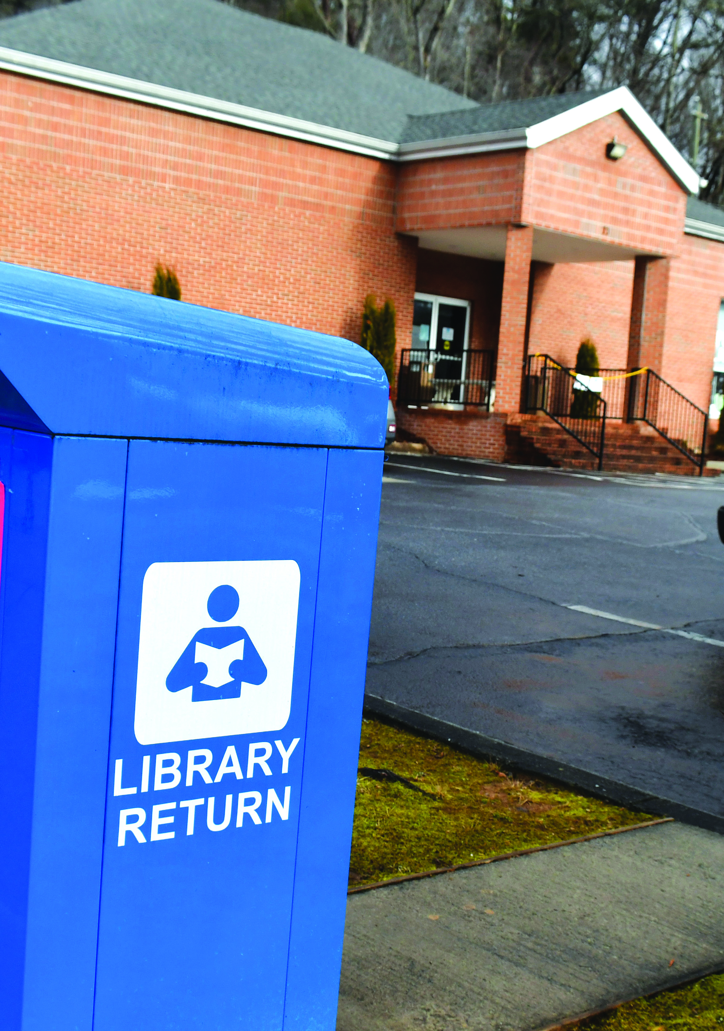 Megan Broome/The Clayton Tribune. Beginning Feb. 1, patrons can once again return books to the blue library return bins located in the parking lot. The feature was closed during the library closure for renovations. No late fees were accumulated for patrons during the closure. 