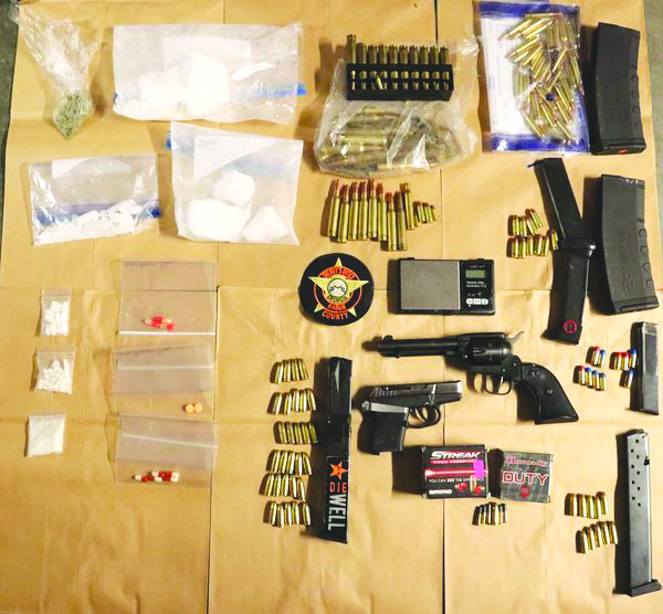 Photo from RCSO Facebook page. Weapons and drugs seized from an unoccupied vehicle in crash.