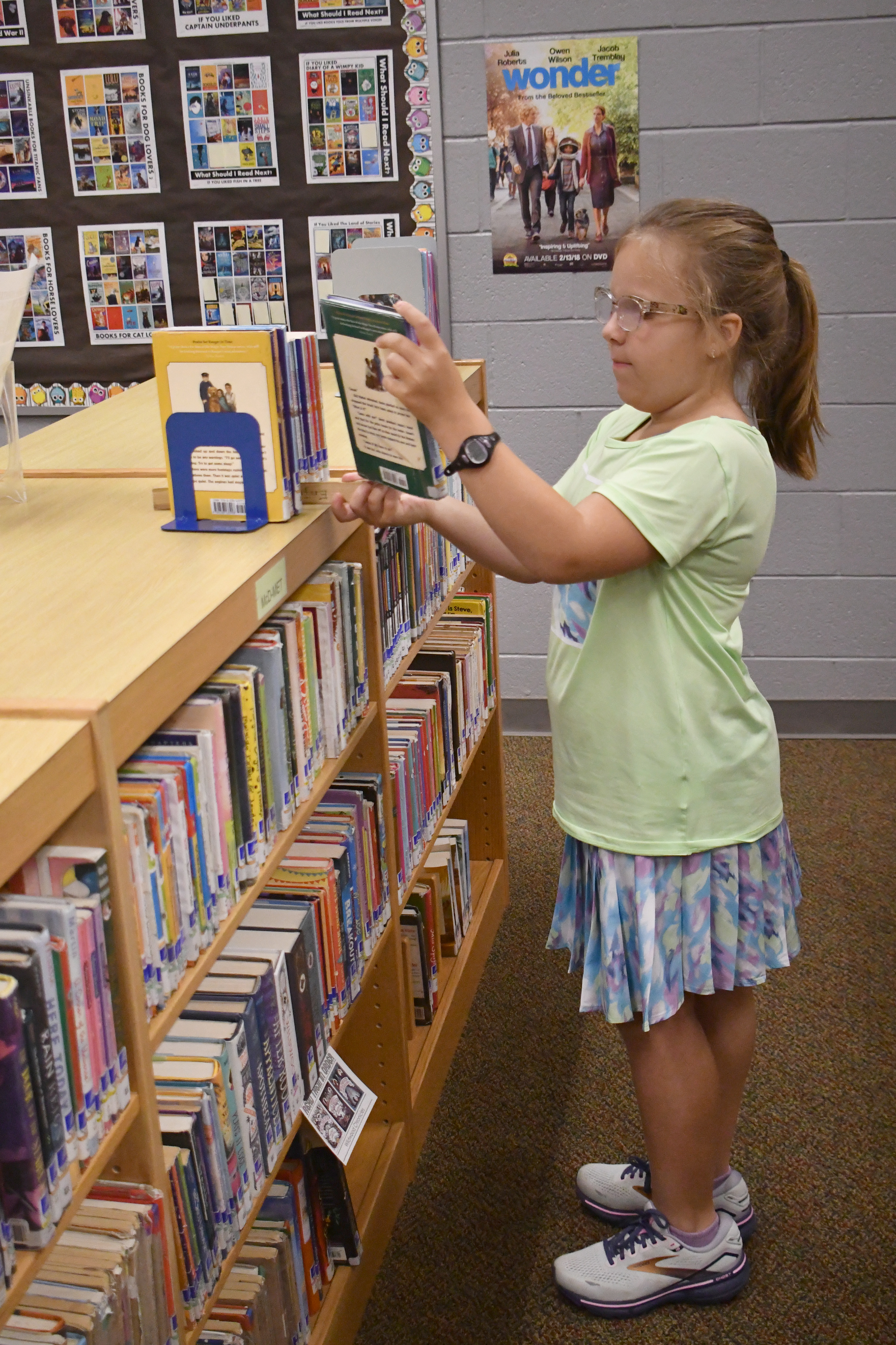 Enoch Autry/The Clayton Tribune. RCES student Reese Dean selects the book “Ranger In Time” from the school library.