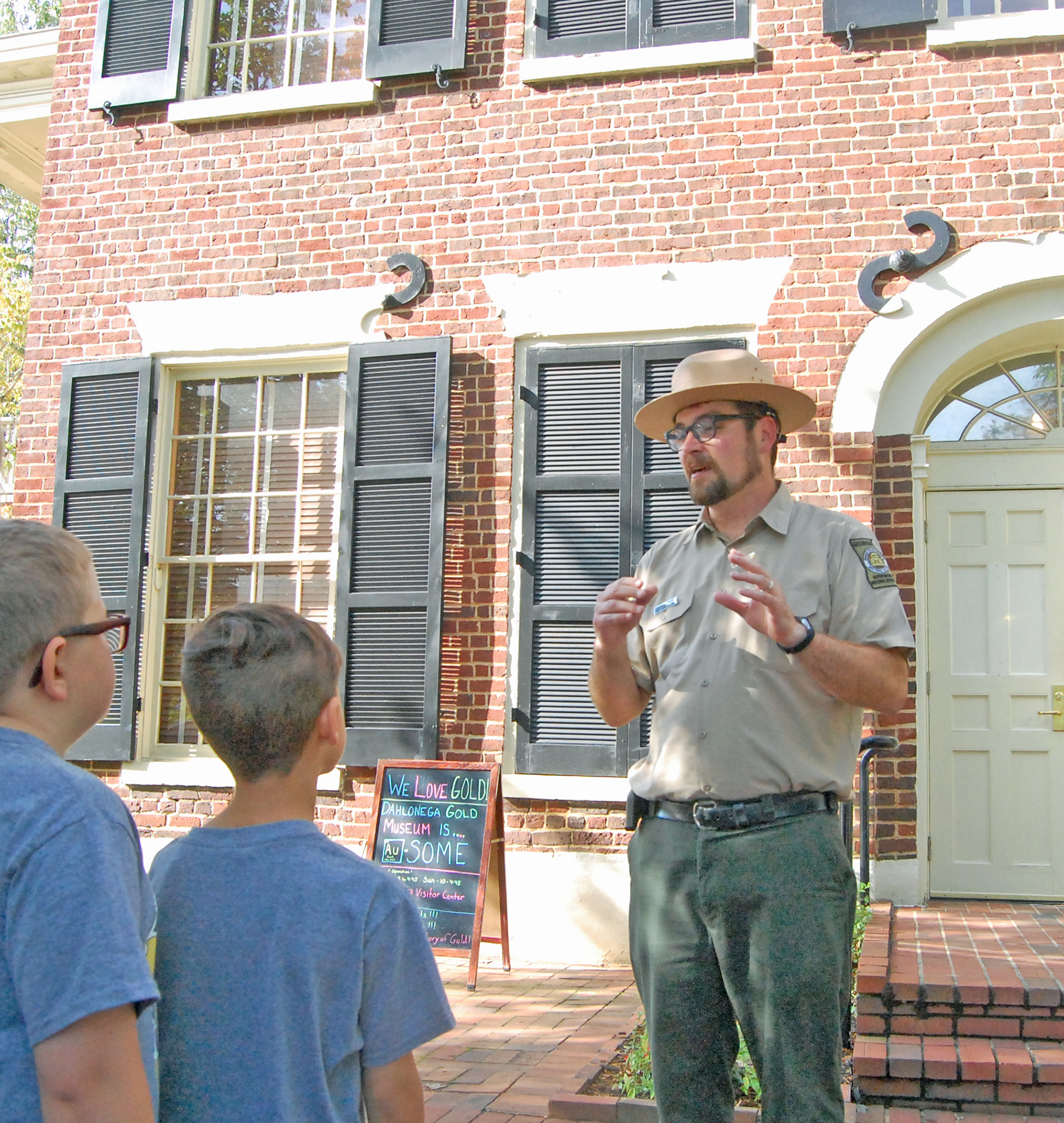 Site manager Sam McDuffie welcomes visitors to the 1836 Lumpkin County courthouse, which now serves as the Gold Museum. (Photo/John Bynum)