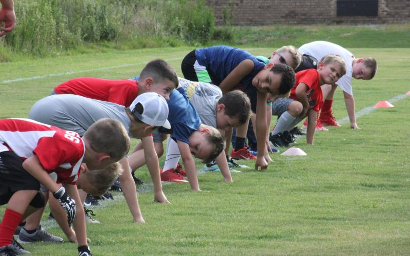 Campers participate in an offensive lineman drill during Rabun County’s Future Wildcats Camp at the football team’s practice field in Tiger on Monday night. (Glendon Poe/The Clayton Tribune)