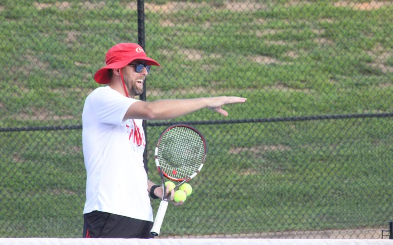 Rabun County tennis coach Bryan Getty instructs players during the Wildcat Tennis Academy at Rabun County High School’s tennis courts Monday night. (Glendon Poe/The Clayton Tribune)