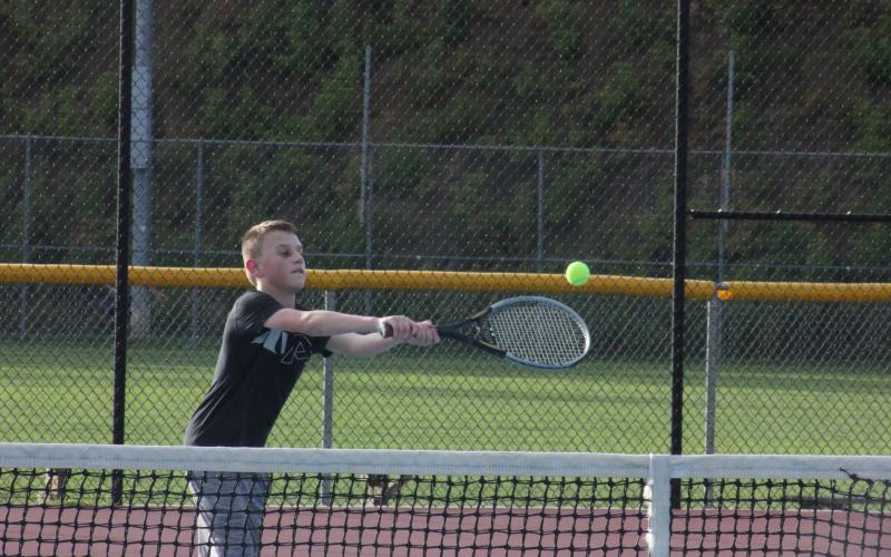 Robbie Fountain reaches for a ball in a return attempt during Rabun County’s Wildcat Tennis Academy at Rabun County High School’s tennis courts in Tiger on Monday night. (Glendon Poe/The Clayton Tribune)