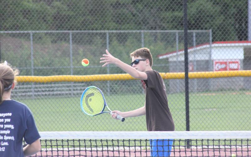 Skylar Spivey serves during a drill at Rabun County's Wildcat Tennis Academy at Rabun County High School's tennis courts in Tiger on Monday night. (Glendon Poe/The Clayton Tribune)