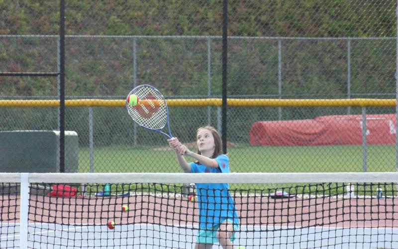 Lorelai Anders makes contact during a volley drill at Rabun County’s Wildcat Tennis Academy at Rabun County High School’s tennis courts in Tiger on Monday night. (Glendon Poe/The Clayton Tribune)