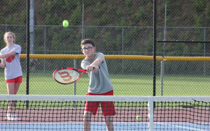 Trent Thompson returns a shot during a drill at Rabun County's Wildcat Tennis Academy at Rabun County High School in Tiger on Monday night. (Glendon Poe/The Clayton Tribune)