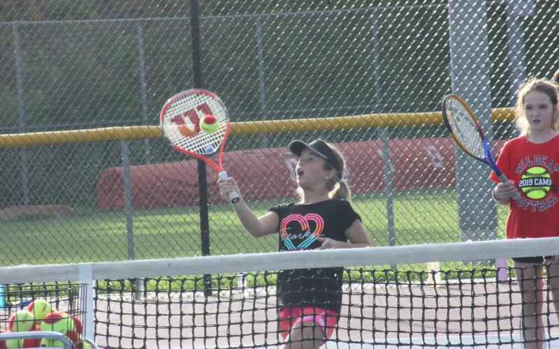 Addison Patton returns a serve during a drill at Rabun County’s Wildcat Tennis Academy at Rabun County High School’s tennis courts in Tiger on Monday night. (Glendon Poe/The Clayton Tribune)