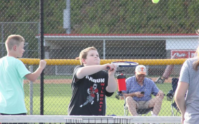 Travis Keener eyes a return during a warm-up exercise at Rabun County’s Wildcat Tennis Academy at Rabun County High School's tennis courts in Tiger on Monday night. (Glendon Poe/The Clayton Tribune)