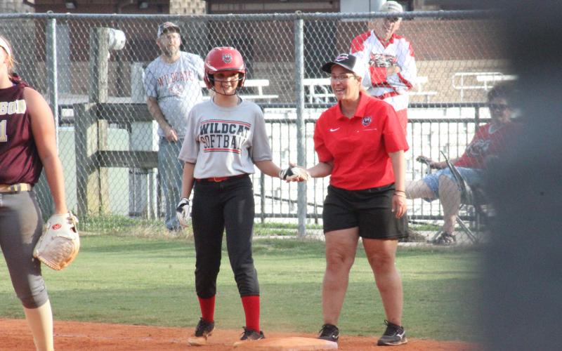 Rabun’s Krissa Cannon and assistant coach Alma Arnold celebrate Cannon beating a throw to first base during a game against Dawson at Rabun County High School in Tiger last Thursday. (Glendon Poe/The Clayton Tribune)