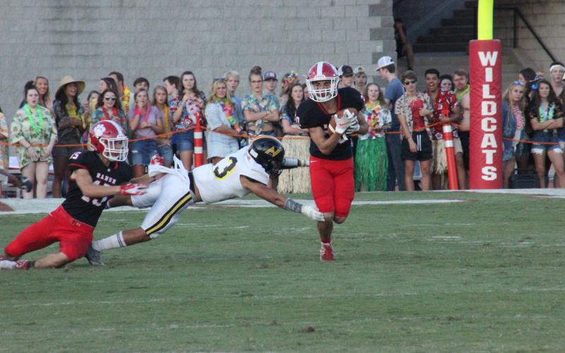 Rabun County wide receiver Sam Adams, left, blocks a North Murray defender, while teammate Sutton Jones, right, runs for additional yards during the first half at Frank Snyder Memorial Stadium in Tiger last Friday night. (Glendon Poe/The Clayton Tribune)