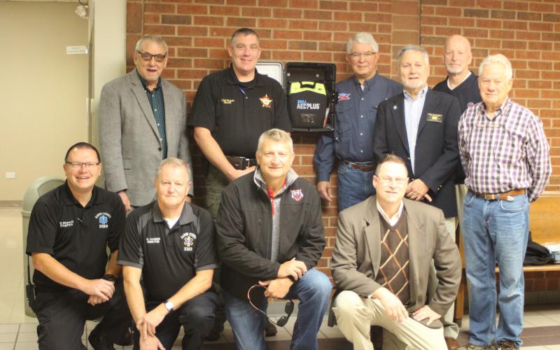 Megan Broome/The Clayton Tribune. The Rotary Club of Clayton has donated four Automated External Defibrillators to Rabun County EMS, two of which replaced old AED’s at the courthouse. Front, from left, Trampes Stancil, EMS captain, Mike Carnes, EMS director, Darrin Giles, county administrator, Tony Penrose; Middle, from left, Tim Ranney, Rotary president, Ray Pagano; Back, from left, Wayne Knuckles, Sheriff Chad Nichols, David Tatum and Matt Mitcham. 