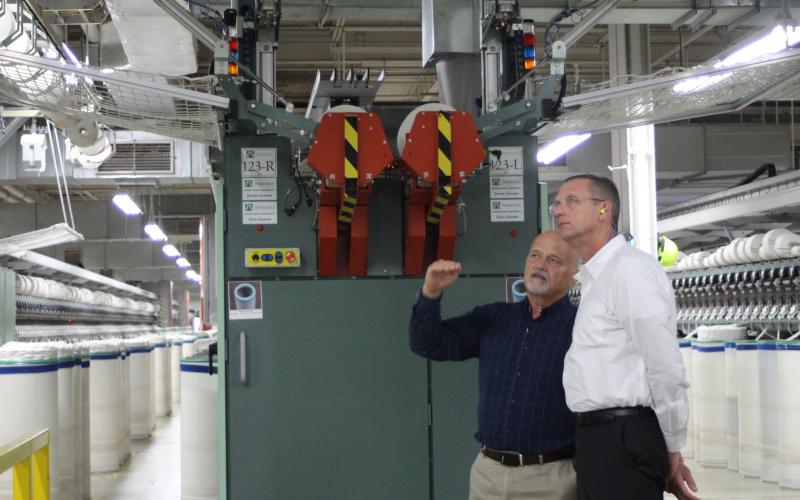 Weldon Wahl, plant manager for the Parkdale Rabun Gap facility, takes Rep. Doug Collins, who represents Georgia’s 9th congressional district, on a tour of the Parkdale textile plant in Rabun County last Thursday. Wahl showed Collins the automated machinery inside the facility and introduced him to some of Parkdale’s employees. Parkdale is one of the largest providers of spun yarns in the world.