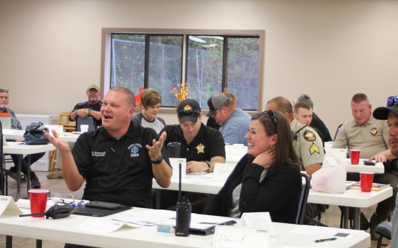 Trampes Stancil, Captain for Rabun County Emergency Medical Services, left, and Chanon Pritchard, Rabun County Sheriff’s Office Deputy, share a laugh during a scenario-based exercise at Peer Support training for public safety officials last Monday. The exercises are used to give a hands-on approach to skills that are taught to public service partners during the program on how to recognize and engage a peer who might be experiencing a personal crisis.