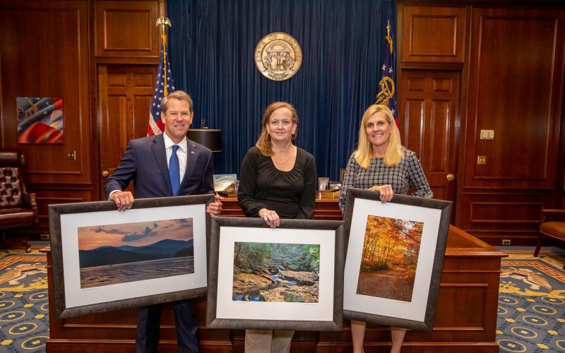Rabun County photographer Michele Crawford, center, with Gov. and Mrs. Brian Kemp
