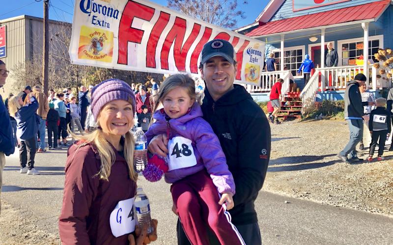 Daniela Cintron/ Allegra Perry, 5, enjoyed an early 5K run with her parents, Austin and Holly, finishing strong in first place in her age category