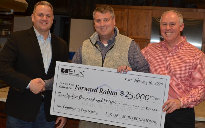 Wayne Knuckles/The Clayton Tribune Todd Webb, left, COO of Elk International, presents a check for $25,000 to Development Authority of Rabun County Board Chairman Claude Dillard (center) and Forward Rabun Director Rick Story at a recent meeting.