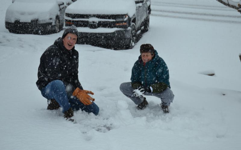 Matthew Osborne/For The Clayton Tribune Jane and Lee McNeil of Athens build an impromptu snow man in Clayton Saturday.