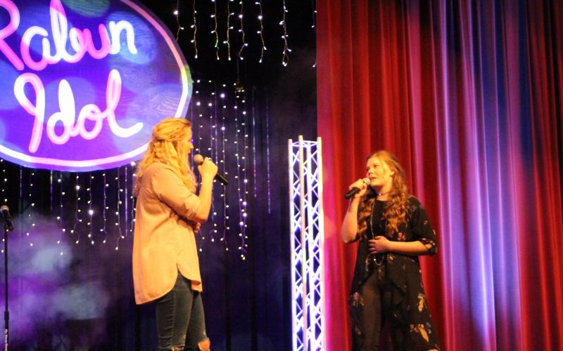 Megan Broome/The Clayton Tribune. Hailey Smith, left, and Hannah Thompson sing a duet of the song “Reckless Love.”