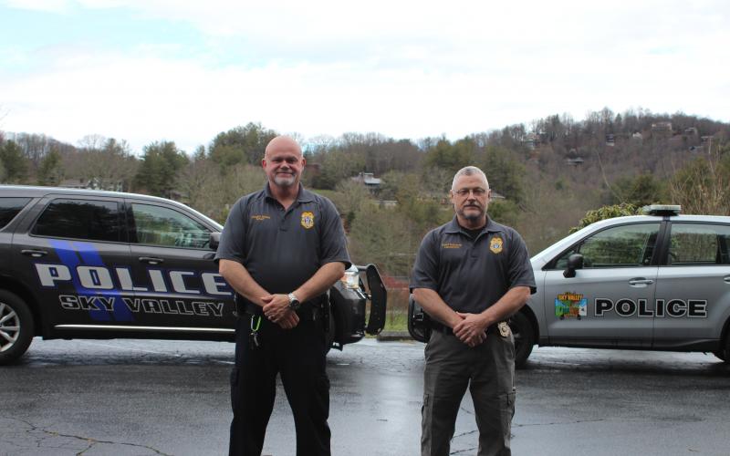 Megan Broome/The Clayton Tribune Sky Valley Chief of Police Vaughn Estes, left, and Lt. David Edwards stand in front of their police vehicles to show the new car the department is getting after council members approved the purchase of a 2020 Dodge Durango and Ram 1500. Shown on the right is one of the Subarus the police officers are currently driving. 