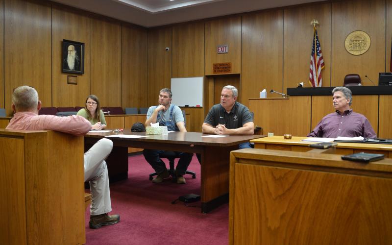 Wayne Knuckles/The Clayton Tribune. From left, County Clerk Linda Ramey and commissioners Will Nichols, Kent Woerner and Greg James at last Thursday's emergency meeting of the Rabun County commission. 