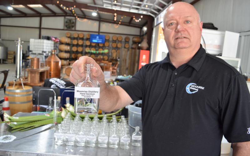 Wayne Knuckles/The Clayton Tribune. Moonrise Distillery in Clayton was one of the first craft distilleries in the nation to convert production to hand sanitizer during the COVID-19 health emergency. Owner Doug Nassaur said Moonrise will continue to make bottles of sanitizer available to local residents as long as it is possible to do so. 