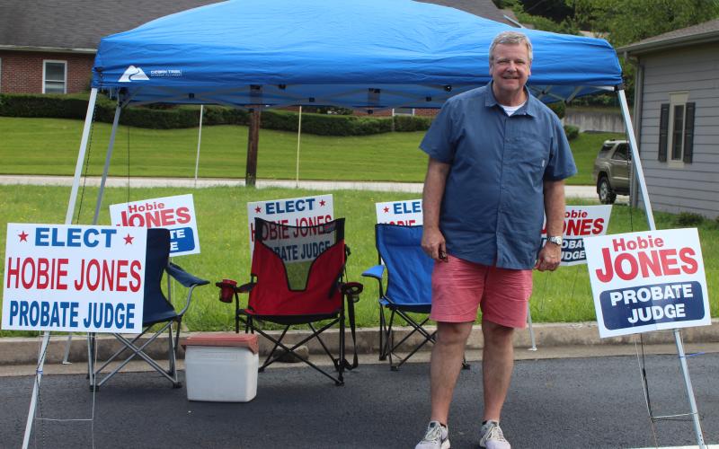 Megan Broome/The Clayton Tribune. Candidate Hobie Jones sets up his tent outside the Civic Center and greets voters as they head to the polls for the primary election on Tuesday. 
