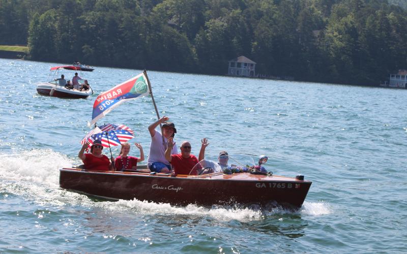 Megan Broome/The Clayton Tribune. The Lake Rabun Association held their annual wooden boat parade on Sunday as part of Fourth of July celebration events to bring the community together.. The wooden boat parade featured rare boats and boats ranging from the 1920s to 1970s.