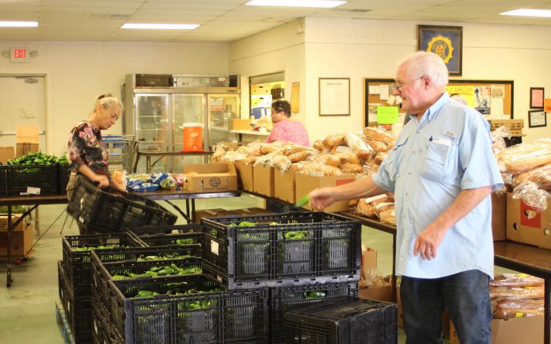 Megan Broome/The Clayton Tribune. Carl Green works to move boxes and organize food to be distributed to residents of the community at the American Legion Post 220 food distribution last Thursday. 