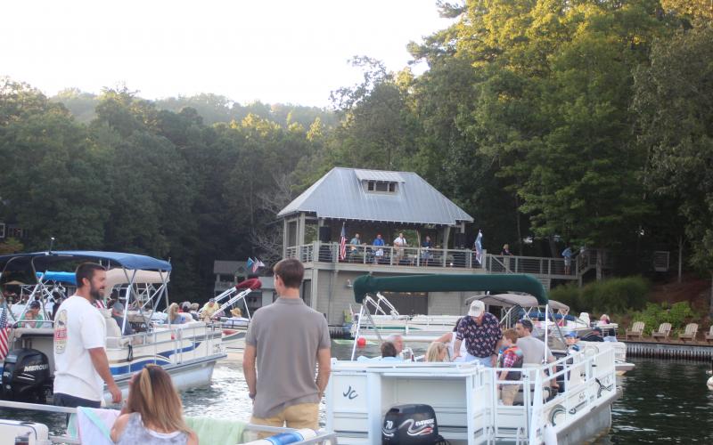 Megan Broome/The Clayton Tribune. Hundreds of boaters turned out for a concert by the Atlanta duo of Banks and Shane Saturday to mark the 100th birthday of Lake Burton.