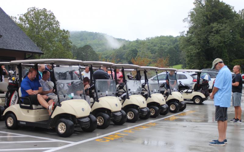 Megan Broome/The Clayton Tribune. Dr. Guy Gober and golf tournament contestants pray before the start of the 16th annual prostate cancer awareness tournament held at the Rabun County Golf Course last Saturday