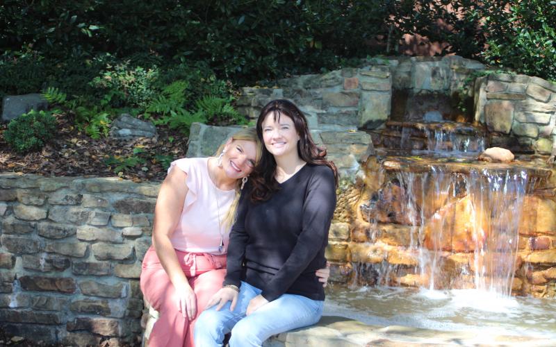 Megan Broome/The Clayton Tribune. Sisters Holly Cabe and Robin Billingsley are both breast cancer survivors and were both diagnosed at age 40. They advocate it's important to get yearly mammograms because they are the key for early detection.