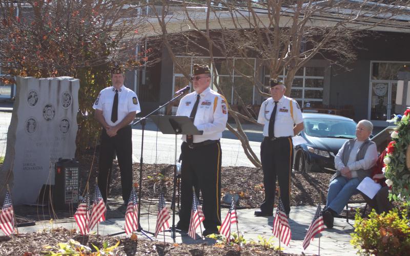 Megan Broome/The Clayton Tribune. Col. (Ret.) Charles Ladd (center) gives a message of encouragement and reflects on the importance of honoring Veterans Day at Saturday’s ceremony. DAV Treasurer Chris Dinofrio, left, and DAV Chapter 15 Commander Doug Wayne listen to his remarks. 