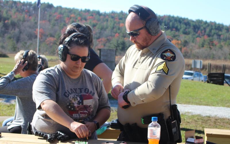 Megan Broome/The Clayton Tribune. Sgt. Riley Owens, right, assists Amber Owens with loading her gun at the Level 3 Firearms Course organized by the Rabun County Sheriff’s Office last weekend. 