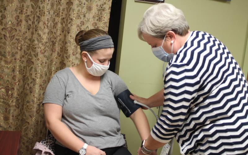 Megan Broome/The Clayton Tribune. Brooke Jones, left, gets her blood pressure taken by new County Nurse Manager Dulene Jones at the Rabun County Health Department. 