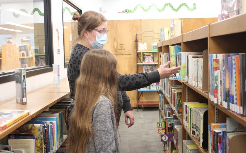 Megan Broome/The Clayton Tribune. Abby Thurmond, left, and Jennifer Thurmond browse books in the newly-renovated children’s section of the library on Tuesday. This was the pair’s first time visiting the library since moving to Rabun County in July and they were excited to see the facility. 