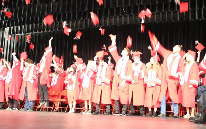 Megan Broome/The Clayton Tribune. Members of the Rabun County High School Class of 2021 cheer and throw tassels in the air after the graduation ceremony last Friday. 