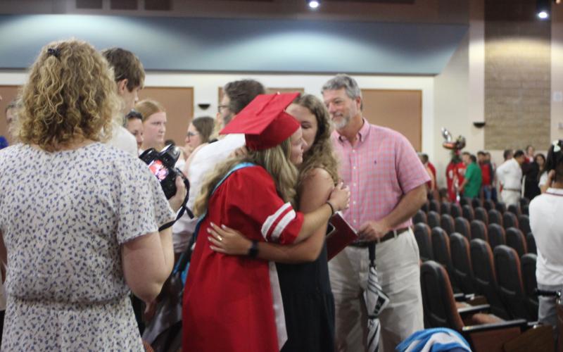 Megan Broome/The Clayton Tribune. Class of 2021 Valedictorian Lauren Barnes cries with tears of joy as she hugs her friend after receiving her diploma at last Friday’s graduation ceremony. 