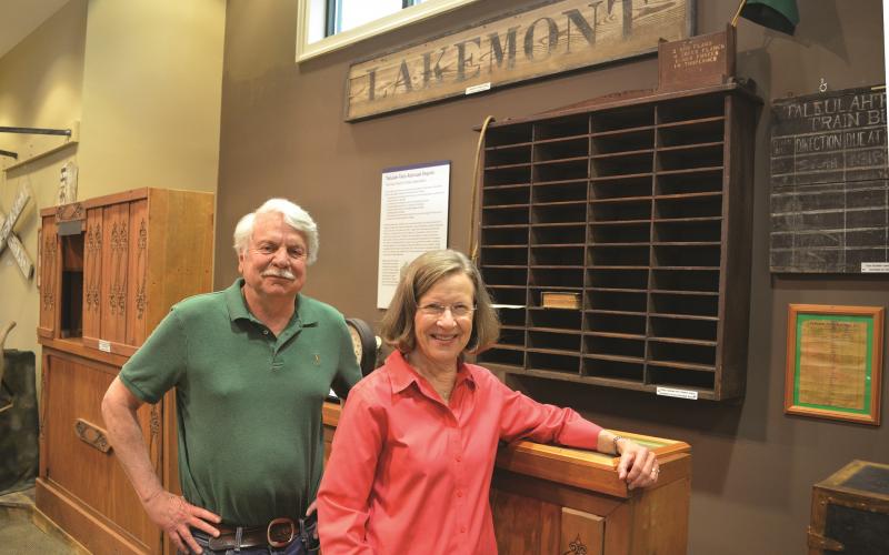 Wayne Knuckles/The Clayton Tribune. Volunteers Dick Cinquina, left, and Linda Bardin show some of the exhibits to be featured when the Rabun County Historical Society reopens Friday, June 11. 