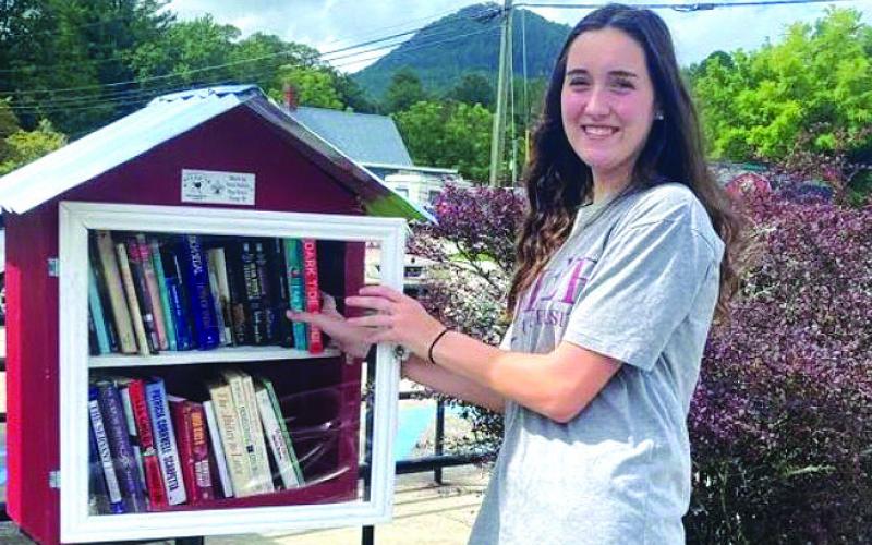 Submitted photo. Community Service -- Donations to Book Box at Tiger, Post Office  Shown with the books location is FBLA member Emily Dugas.