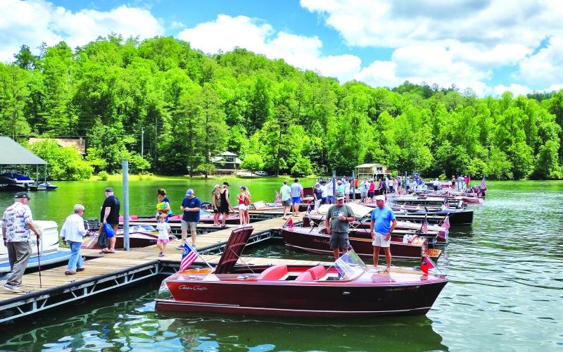 Megan Broome/The Clayton Tribune. Spectators from North Georgia and beyond flock to LaPrade’s Marina on Lake Burton to view the wooden boats that set sail in the Lake Burton Wooden Boat Parade during Memorial Day weekend this year.
