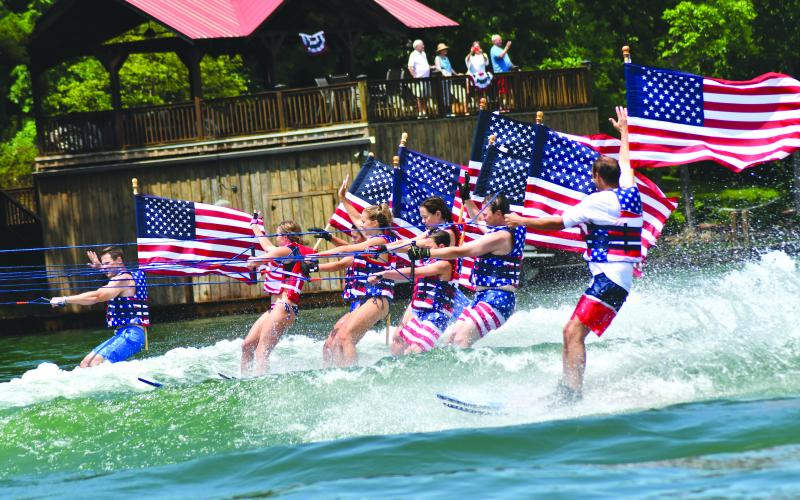 Enoch Autry/The Clayton Tribune. Ski Patriots wave to the crowds on July 3.