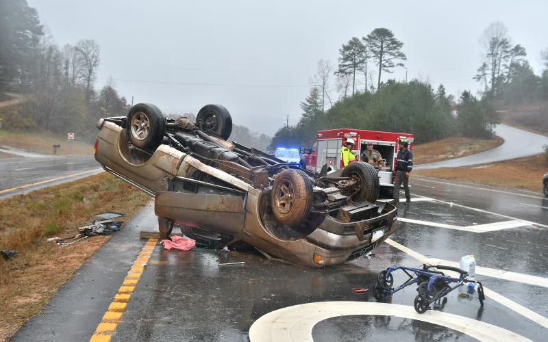 Megan Broome/The Clayton Tribune. First responders work the scene of a single vehicle crash for a vehicle that overturned on Ga. 15 at Razorback Lane in Lakemont Nov. 11. The driver, a Clarkesville, Ga. man, sustained possible minor injuries as a result of the crash. 