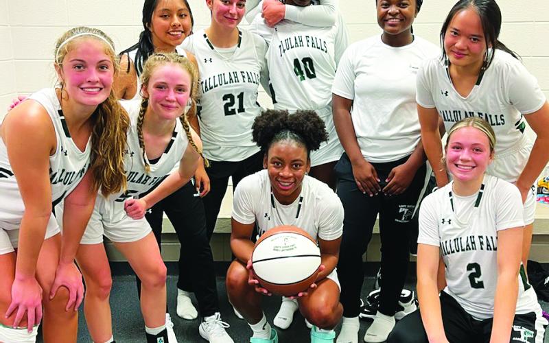 TFS Athletics. Senior Denika Lightbourne (center) poses with her TFS teammates after scoring 1,000 points in her career. She now holds three school records as well as being the fifth Lady Indian to score 1,000 points.