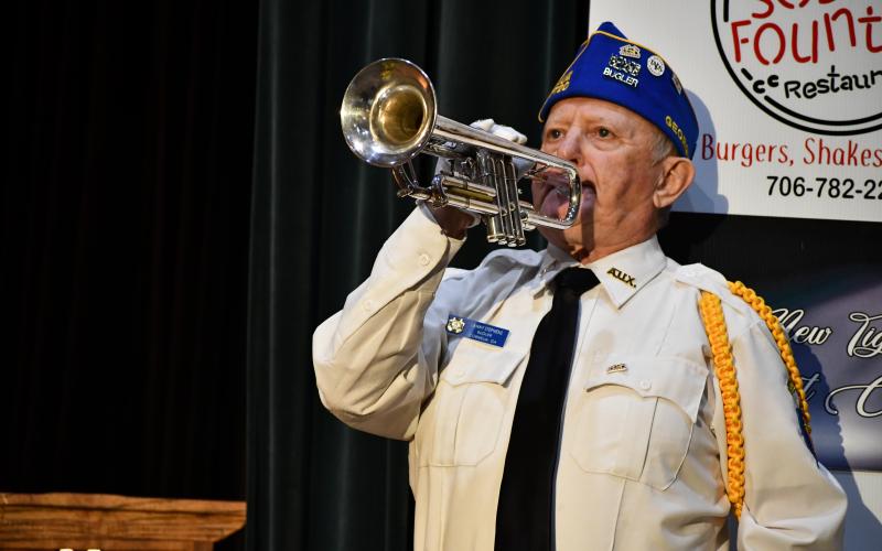 Megan Broome/The Clayton Tribune. Bugler Danny Stephens performs “Taps” to conclude the program for the Veterans Appreciation Dinner.