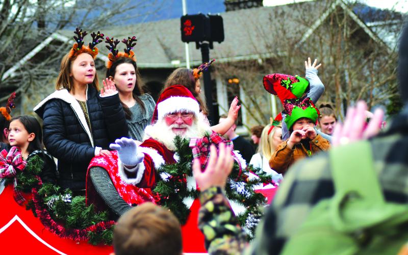 Enoch Autry/The Clayton Tribune. Santa Claus waves toward children and adults at the Dec. 3 parade near The Rock House on Main Street.