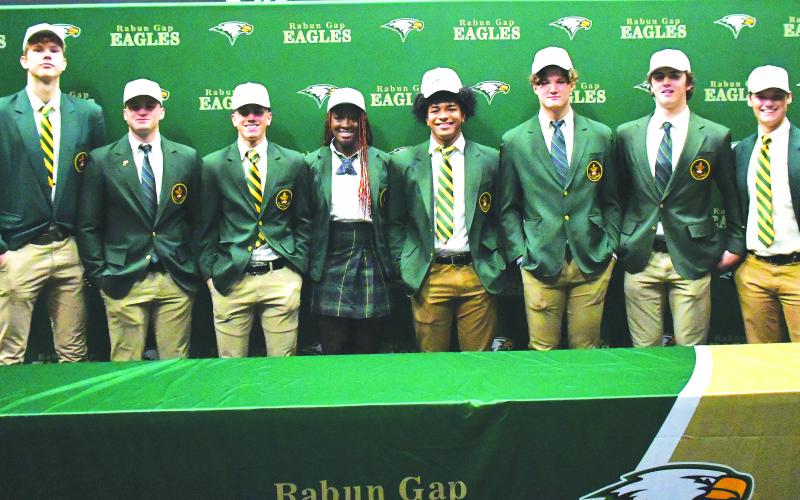Luke Morey/The Clayton Tribune. On Wednesday, Dec. 7, eight Rabun Gap-Nacoochee School seniors signed their Letters of Intent to play at the collegiate level. From left, Domas Kauzonas (University of North Carolina Greensboro); Brody Roulier (Missouri S&T); Lewis Rodriguez (Marist); Calea Jackson (University of Miami): Armani Guzman (West Virginia); Nickolas Roy (University of Buffalo); Dylan Alonso (Middle Tennesee State) and Luke Earnhardt (Middle Tennessee State). 